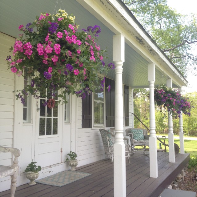 tiny-farmhouse-porch-with-hanging-baskets | tiny farmhouse